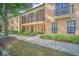 Attractive two-story condo exterior with manicured landscaping, walkway, porch and balcony at 506 Mirasol Cir # 202, Celebration, FL 34747