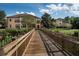 Exterior view of a community via bridge, with lush foliage and blue skies at 506 Mirasol Cir # 202, Celebration, FL 34747