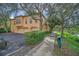 Stunning exterior view of home with lush landscaping and a three-car garage at 506 Mirasol Cir # 202, Celebration, FL 34747