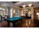 Inviting game room featuring a classic pool table, hardwood floors, and abundant natural light at 506 Mirasol Cir # 202, Celebration, FL 34747