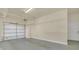 Spacious two-car garage with white door, overhead lighting, and ample space for parking and storage at 506 Mirasol Cir # 202, Celebration, FL 34747