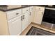 Kitchen features white cabinets, stainless steel oven, and tile flooring, with dark handles and knobs at 506 Mirasol Cir # 202, Celebration, FL 34747