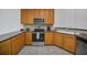 Spacious kitchen featuring stainless steel appliances, wood cabinets and light color tile flooring at 506 Mirasol Cir # 202, Celebration, FL 34747
