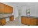 Spacious kitchen featuring tile floors, wood cabinets, stainless steel appliances and a workspace at 506 Mirasol Cir # 202, Celebration, FL 34747