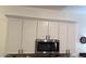 Modern kitchen boasts white cabinets and stainless steel microwave, combining style and functionality at 506 Mirasol Cir # 202, Celebration, FL 34747