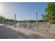 Scenic lake view with decorative flags along the walkway, framed by trees and bright blue skies at 506 Mirasol Cir # 202, Celebration, FL 34747