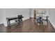 View of living room featuring a dark wood floor, study table, and dining area with a four-chair table at 506 Mirasol Cir # 202, Celebration, FL 34747
