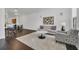 Open living space showcases hardwood floors, neutral tones, modern furnishings, and natural light at 506 Mirasol Cir # 202, Celebration, FL 34747