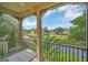 Relaxing screened patio featuring black railings, a ceiling fan, and a pleasant view of the water at 506 Mirasol Cir # 202, Celebration, FL 34747