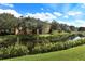 Peaceful pond view of the community buildings showcasing mature trees and landscaped surroundings at 506 Mirasol Cir # 202, Celebration, FL 34747