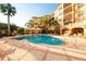 Beautiful pool featuring a brick deck, seating, and palm trees in a resort-style setting at 506 Mirasol Cir # 202, Celebration, FL 34747