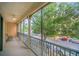 View from porch overlooking the street and surrounding greenery, with chairs and a ceiling fan at 506 Mirasol Cir # 202, Celebration, FL 34747