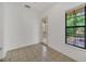 This room features tile floors, a window with natural light, and a glass door at 506 Mirasol Cir # 202, Celebration, FL 34747