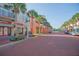 Picturesque street with colorful buildings, palm trees, and decorative accents along a brick-paved road at 506 Mirasol Cir # 202, Celebration, FL 34747