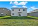 Spacious backyard featuring lush green grass and a view of the home's exterior at 5135 Marshelder St, Apopka, FL 32712