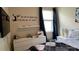 Comfortable bedroom featuring a bed, side table, soft natural light from the window, and calm interior decor at 5169 Dove Tree, Orlando, FL 32811