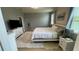 A cozy bedroom featuring a comfortable bed, fluffy rug, and a bright window that lets in natural light at 5169 Dove Tree, Orlando, FL 32811