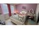 Cozy bedroom with a bed, desk, and decoratively painted purple walls at 5169 Dove Tree, Orlando, FL 32811