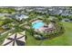 A beautiful aerial view of a large community pool, playground, and lounge area surrounded by lush greenery at 5169 Dove Tree, Orlando, FL 32811