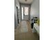 Hallway with a tiled floor, a decorative rug, a door, and a potted plant, with a chandelier overhead at 5169 Dove Tree, Orlando, FL 32811