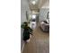Hallway with a tiled floor, a decorative rug, and a side table with a potted plant, with an open view of the living room at 5169 Dove Tree, Orlando, FL 32811