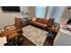 Comfortable home office with brown leather futon, desk, and blue patterned rug at 5169 Dove Tree, Orlando, FL 32811