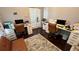 Spacious home office with dual workstations, brown leather chairs, and ample lighting at 5169 Dove Tree, Orlando, FL 32811