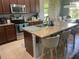 Stylish kitchen with stainless steel appliances, granite countertops, and bar seating at 5169 Dove Tree, Orlando, FL 32811