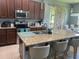 Modern kitchen with stainless steel appliances, granite countertops, and bar seating at 5169 Dove Tree, Orlando, FL 32811