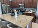 Modern kitchen with stainless steel appliances, granite countertops, and barstool seating at 5169 Dove Tree, Orlando, FL 32811