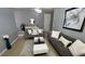 Bright living room with modern gray sofas, stylish coffee tables, and decorative art pieces at 5169 Dove Tree, Orlando, FL 32811