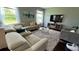 Living room featuring a comfortable sectional sofa, a plush rug, and large windows offering scenic views at 5169 Dove Tree, Orlando, FL 32811