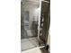Elegant walk-in shower featuring modern fixtures, neutral-toned stone tiling, and glass door at 5169 Dove Tree, Orlando, FL 32811