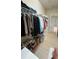Large walk-in closet with an array of clothing, shoes, and storage options for convenient organization and accessibility at 5169 Dove Tree, Orlando, FL 32811