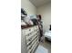 Walk-in closet featuring classic shelving, a dresser with drawers, and ample storage for an organized wardrobe at 5169 Dove Tree, Orlando, FL 32811