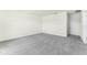 Spacious bedroom with neutral walls, gray carpeting and a doorway entrance at 5242 Scrub Mint Ln, Apopka, FL 32712