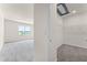 Hallway view showcasing the bedroom with scenic views and the walk-in closet with shelving at 5242 Scrub Mint Ln, Apopka, FL 32712