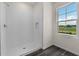 Shower featuring white tile, rainfall shower head, built in niche, and a window at 5242 Scrub Mint Ln, Apopka, FL 32712