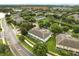 Community aerial view featuring lush landscaping, a serene pond, and well-maintained buildings at 6027 Strada Isle Way, Orlando, FL 32835