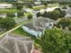 An aerial shot of townhomes near a pond and bridge enveloped by mature landscaping at 6027 Strada Isle Way, Orlando, FL 32835