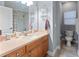 Bathroom featuring a single sink vanity with a mirror and a tiled shower at 6027 Strada Isle Way, Orlando, FL 32835
