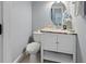Elegant powder room with marble countertop, stylish mirror, and modern fixtures at 6027 Strada Isle Way, Orlando, FL 32835