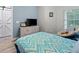 Cozy bedroom features a comfortable chair, a dresser with TV, and natural light at 6027 Strada Isle Way, Orlando, FL 32835