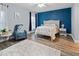 Stylish bedroom with a tufted headboard, accent wall, and soft rug creates a relaxing space at 6027 Strada Isle Way, Orlando, FL 32835
