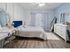 Comfortable bedroom features decor mirror, vanity, windows and hardwood flooring at 6027 Strada Isle Way, Orlando, FL 32835