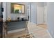 Stylish foyer with tiled floor, decorative table, mirror, and white doors at 6027 Strada Isle Way, Orlando, FL 32835