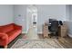 Spacious hallway with hardwood floors, desk, red sofa, and convenient storage closet at 6027 Strada Isle Way, Orlando, FL 32835