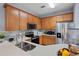 Modern kitchen with stainless steel appliances, light countertops, and wood cabinets at 6027 Strada Isle Way, Orlando, FL 32835