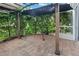 Private brick patio with shade cover, surrounded by lush landscaping for outdoor enjoyment at 6027 Strada Isle Way, Orlando, FL 32835