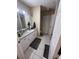 Well-lit bathroom with granite countertop and ample cabinet space at 6328 Raleigh St # 814, Orlando, FL 32835